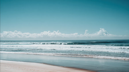 A tranquil beach scene showcasing gentle waves lapping at the sandy shore under a vast blue sky. The serene atmosphere invites relaxation and adventure, perfect for escapes.の素材