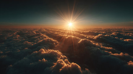 An awe-inspiring view of a stunning sunrise breaks over a vast sea of fluffy clouds, showcasing nature's brilliance with golden rays illuminating the tranquil sky.の素材