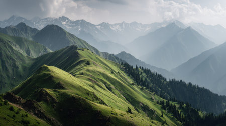 Explore a breathtaking mountain landscape featuring lush green hills and majestic peaks. The clouds add drama to the serene atmosphere, ideal for nature lovers.の素材