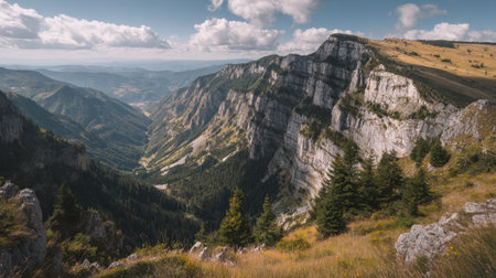 Explore a captivating mountain landscape featuring dramatic cliffs, lush green forests, and a picturesque valley under a vibrant cloudy sky. Perfect for nature lovers!の素材