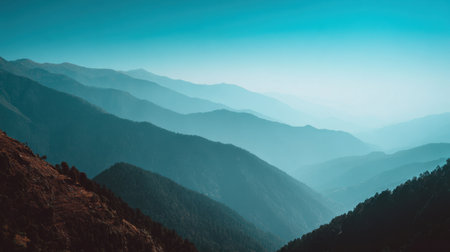This breathtaking mountain landscape captures the serene beauty of layered peaks under a soft blue sky. An ideal setting for nature lovers and travelers seeking tranquility.の素材