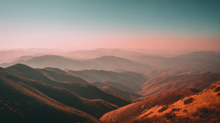 Breathtaking mountain landscape showcasing rolling hills bathed in warm colors, enveloped in soft mist, perfect for evoking feelings of calm and tranquility.の素材