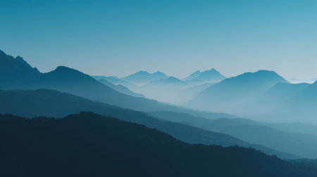 A breathtaking view of layered mountains enveloped in fog and mist. The serene atmosphere evokes a sense of calm and invites exploration of natural beauty.の素材