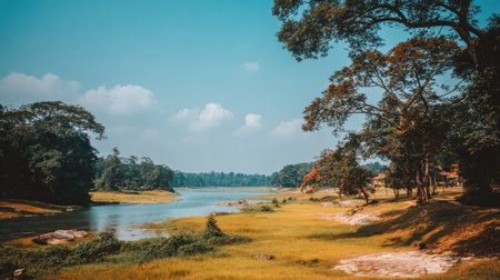 Immerse in the tranquility of this beautiful river landscape featuring lush greenery, clear blue skies, and a peaceful atmosphere perfect for nature lovers.の素材