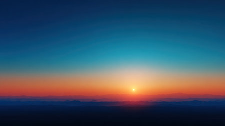 A breathtaking sunrise illuminates the mountain horizon, featuring vibrant orange and blue hues blended seamlessly in the sky, creating a peaceful morning atmosphere.の素材