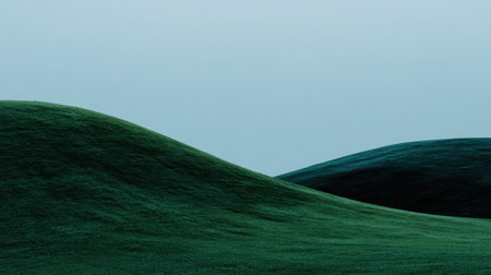 Captivating rolling green hills display gentle curves and textures against a soft sky, perfect for conveying tranquility and natural beauty in design and art projects.の素材
