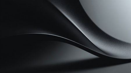 A close-up of a sleek, textured black surface showcasing smooth curves, elegant light and shadow interplay, ideal for concepts in modern design and minimalistic art.の素材