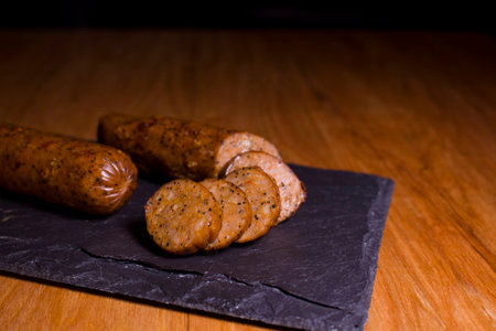 Sliced sausages on a granite slab.の写真素材