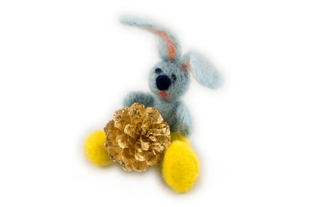Blue hare (rabbit) in yellow felt boots with pine cone