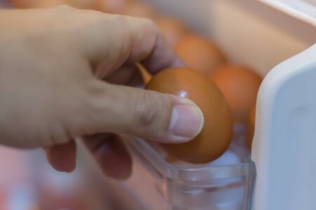 Pick up the chicken eggs from the refrigerator.の写真素材