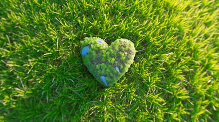 Earth Day planet in the shape of a heart on a lush meadow. GENERATE AIの素材