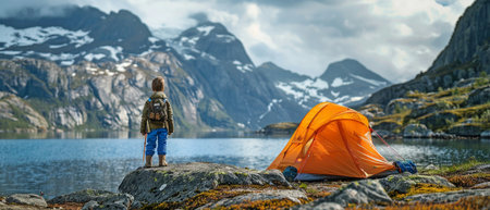 Smiling child on an adventurous family vacation with camping tent gear, hiking, and a healthy outdoor lifestyle while visiting Norway's highlands.の素材