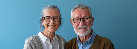 illustration of a contented elderly couple with gray hair and white, flawless teeth, separated on a blue backdrop with text space. dental attention. artificial teeth. dental careの素材