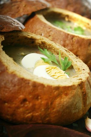 Traditional Polish soup made from fermented rye, served in bread .の写真素材