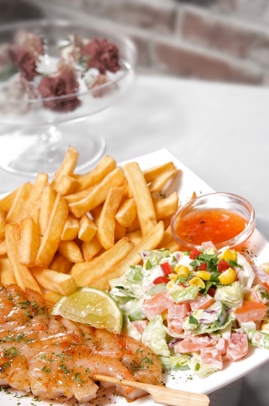 Grilled Shrimp skewers served with french fries and salad  Selective focus on schrimps の写真素材