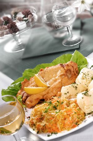 Schnitzel on white plate served with lemon and potattoes. Selective focus.の写真素材