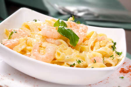 Prepared Shrimp with linguine noodles and creamy garlic sauce on top green basil spring  Selective focus の写真素材