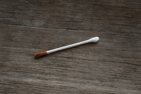 Image of cotton buds dirty on wooden floor