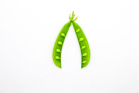 Green peas isolated white backgroundの写真素材