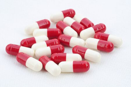 Medicinal pills piled up a bunch of closeup isolate on white background. 