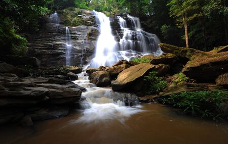 Water fall in spring season located in deep rain forest jungle 