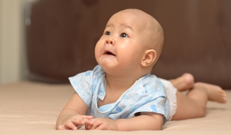 Innocent baby on bed  very cute  の写真素材