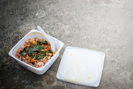 Junk food, fried rice, fried Pork with Basil in plastic box on the floor.の写真素材