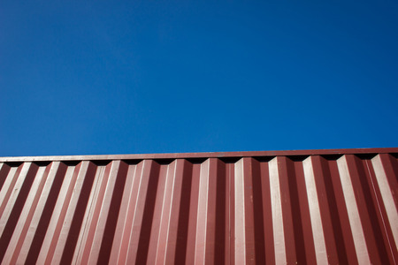 Red cargo container against blue sky for background.の写真素材