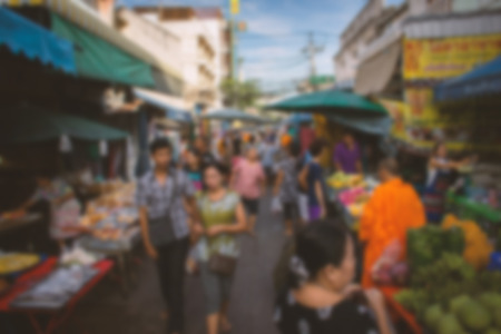Blurred image of people walking in the market. Abstract background.