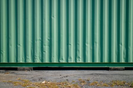 Old metal sheet roof texture. Green cargo container with Concrete floors. Vintage or retro style...