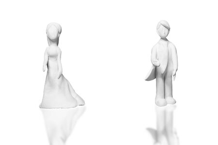 The statues from the white clay is a man and woman who is a lover or couple on a white background with clipping path. Ideas about the day of love or valentine's day.の写真素材