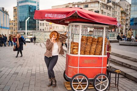 The girl with a donut on the street in Istanbul. The street food.の写真素材