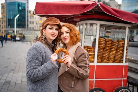 The girl with a donut on the street in Istanbul. The street food.の写真素材