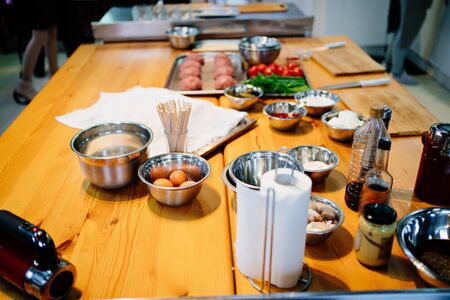 The ingredients for the burgers on the table in the kitchen. Master class from the chefの写真素材