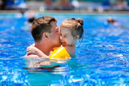 dad and daughter play and cuddle in the pool. Family summer beach vacation. Turkish hotel.の写真素材