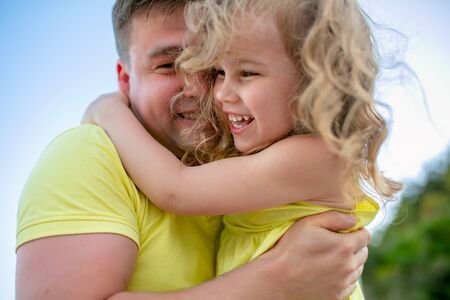 dad and daughter hug and laugh. Loving parents and a happy family. Vacation.の写真素材