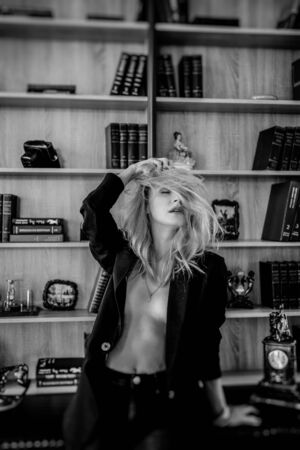 close up beautiful blonde girl in an unbuttoned black jacket with her eyes closed. Black and Whiteの写真素材