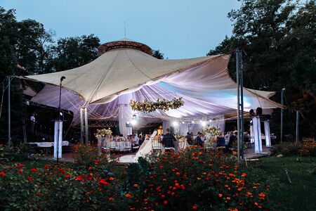 wedding tent in the evening in the Park. A place to celebrate the bride and groom in the open air.