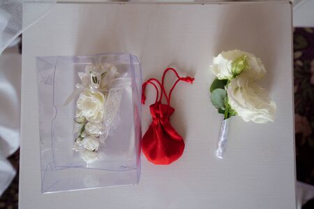boutonniere, garter and bag with jewelry. Wedding accessories