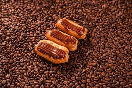 cakes with chocolate icing on coffee beans. Close-up. copy space.の写真素材