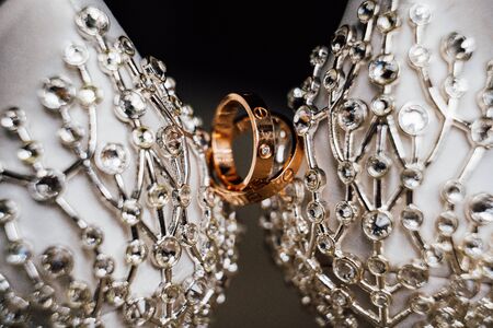 close up wedding rings bride shoes heel shoes with metal decoration