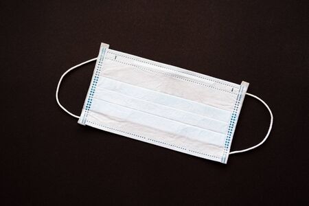 disposable medical mask on a black background. isolated objects. close upの写真素材