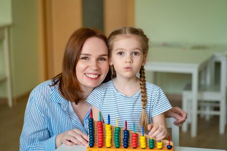 mom with a girl learning to add and subtract with mixed accounts. educational classes for children.の写真素材