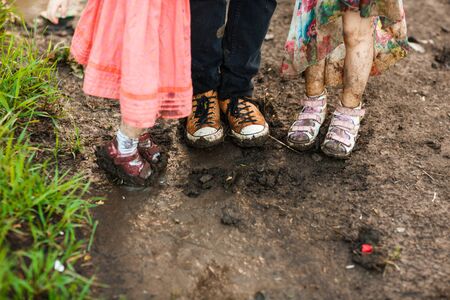 dirty shoes. goes in the dirty dirt road. earth after a rain. off-road. near a field.