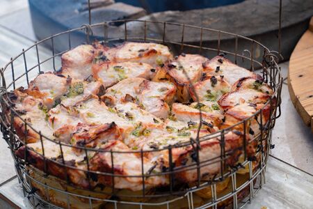meat and potatoes cooked inside a tandoor, a stone oven in the garden.の写真素材