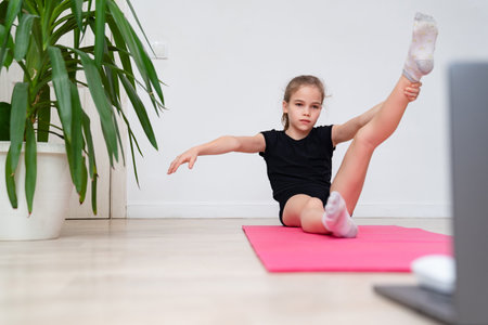 girl teen sports home. gymnastics online. dancing on the quarantine. stretching on a gym Mat.