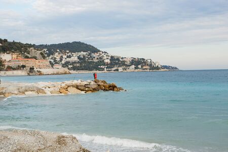 a pair of lovers, a man and a woman standing on the breakwater over the sea. a romantic trip together.の写真素材