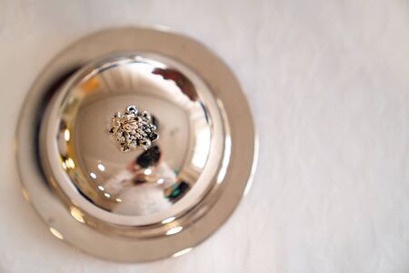 shiny metal cover from the saucer. the design element of the festive table. beautiful tableware. copy space.の写真素材