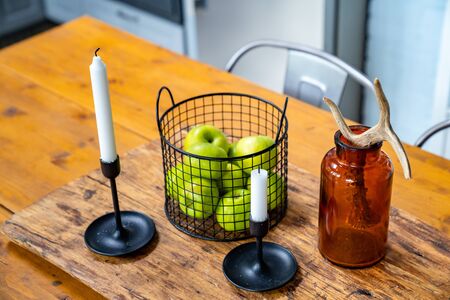 apples and candles a wooden table. kitchen in a Scandinavian style. comfortable and practical interior.の写真素材