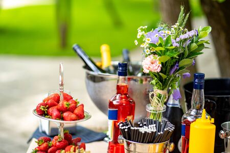 catering. the outdoor table with strawberries, beverages, flowers. a festive table. buffet.の写真素材